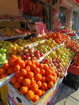 a fruit stand with apples oranges and other fruits at Pomorie Chaika Home in Pomorie