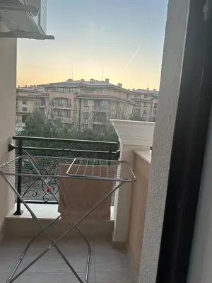 a balcony with a table and a view of a city at Premium Ferienwohnung SWETI WLAS Polarstar Beach Luxury Apartment 150 m zum Strand Pool 3 Balkone Meeresblick Google TV bis zu 6 Personen in Sveti Vlas