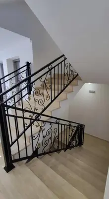a staircase with a black metal railing in a house at Premium Ferienwohnung SWETI WLAS Polarstar Beach Luxury Apartment 150 m zum Strand Pool 3 Balkone Meeresblick Google TV bis zu 6 Personen in Sveti Vlas