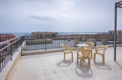 a patio with a table and chairs on a balcony at Sorrento Sole Mare Apartments in Sveti Vlas