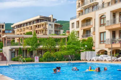 a group of people in a swimming pool in a hotel at Sorrento Sole Mare Apartments in Sveti Vlas