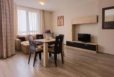 a living room with a table and chairs and a couch at Sorrento Sole Mare Apartments in Sveti Vlas
