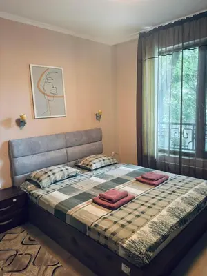 a bedroom with a bed with two pillows and a window at Varna Top Center 1 in Varna City