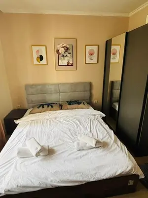 a bedroom with a large white bed with two towels on it at Varna Top Center 1 in Varna City