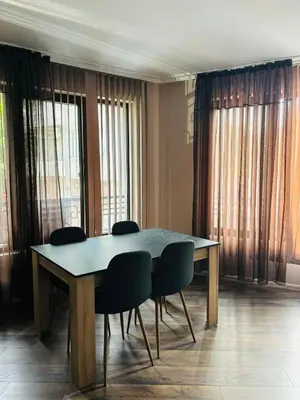 a dining room table with four chairs and windows at Varna Top Center 1 in Varna City