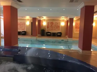 a large pool of water in a hotel lobby at STUNNING VILLA with PRIVATE POOL in Kableshkovo