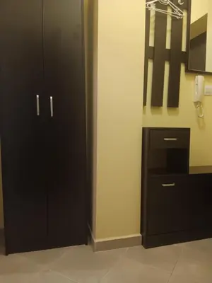 a bathroom with a black cabinet and a mirror at One-room boutique at Sunrise All Suites in Obzor