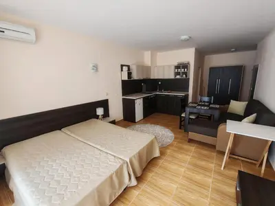 a bedroom with a bed and a living room at Magic Dreams Apartments in Sveti Vlas