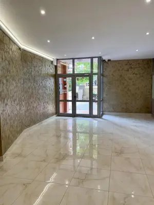 an empty room with a large window and a marble floor at Seaside Apartment Nesebar in Nesebar