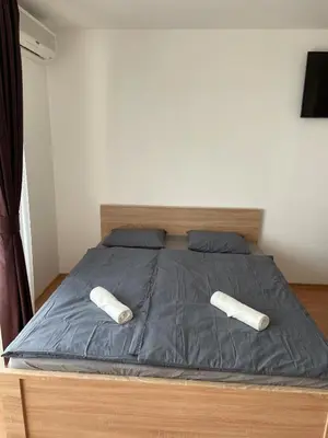 a bed with two pillows on top of it at Peter Apartmanbulgaria-Crown Fort Noks in Sveti Vlas