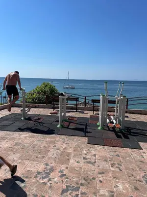 a man running on the beach near the ocean at Peter Apartmanbulgaria-Crown Fort Noks in Sveti Vlas