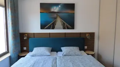 a bedroom with two beds and a picture of a bridge at Polarstar Apartment Verona in Sveti Vlas