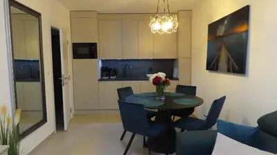 a dining room and kitchen with a table and chairs at Polarstar Apartment Verona in Sveti Vlas