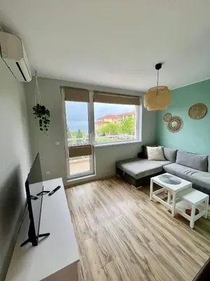 a living room with a couch and a table at Black Sea Breeze Apartment No 3 in Byala