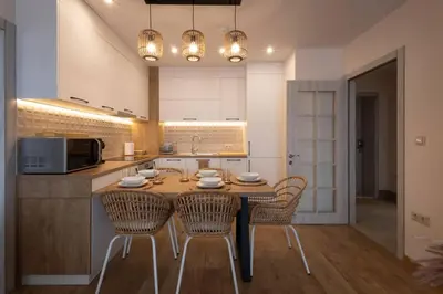 a kitchen with a table with chairs and a microwave at Marina Varna Apartment-2BDR at South Bay Complex in Varna City