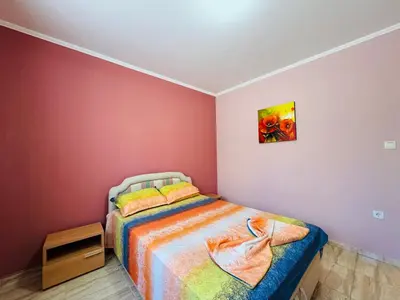a bedroom with a bed and a painting on the wall at ВОДЕНИЦАТА 2-6 Apartment Sveti Vlas in Sveti Vlas