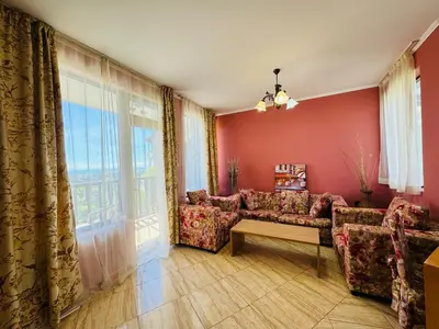 a living room with a couch and a window at ВОДЕНИЦАТА 2-6 Apartment Sveti Vlas in Sveti Vlas
