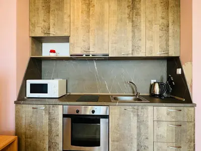 a kitchen with a microwave and a sink at ВОДЕНИЦАТА 2-6 Apartment Sveti Vlas in Sveti Vlas