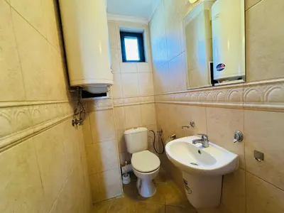 a bathroom with a toilet and a sink and a mirror at ВОДЕНИЦАТА 2-6 Apartment Sveti Vlas in Sveti Vlas
