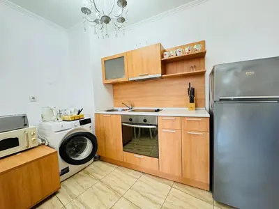 a kitchen with a stainless steel refrigerator and a dishwasher at VODENICATA 4-10 Apartment Sveti Vlas in Sveti Vlas