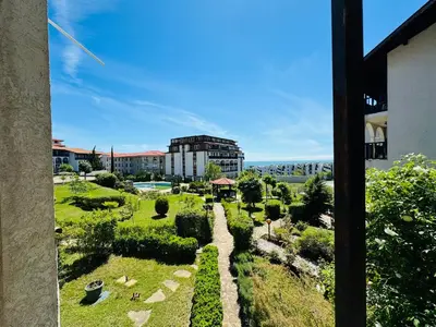 a view of a garden with a building in the background at VODENICATA 4-10 Apartment Sveti Vlas in Sveti Vlas