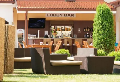 a restaurant with chairs and a bar in the background at Sunrise apartment 2 bedrooms in Obzor
