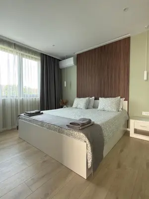 a bedroom with a large bed and a large window at Courtyard Villa, Aleksandrovo in Aleksandrovo