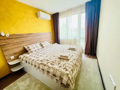 a bedroom with a bed and a window at Music in the sea in Varna City