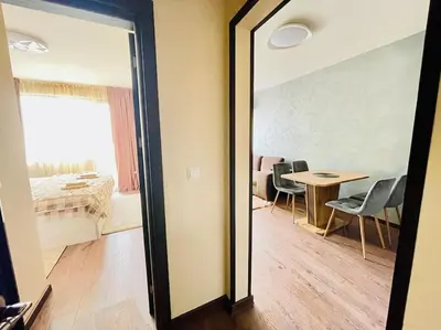 a mirror in a room with a bedroom and a table at Music in the sea in Varna City