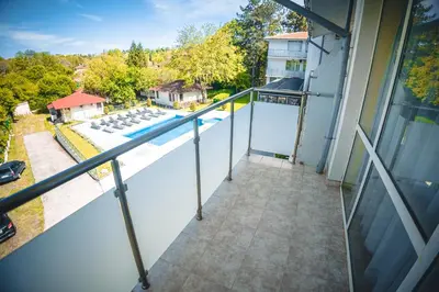 an empty balcony of a house with a swimming pool at Хотел и Вили Марая in Tsarevo