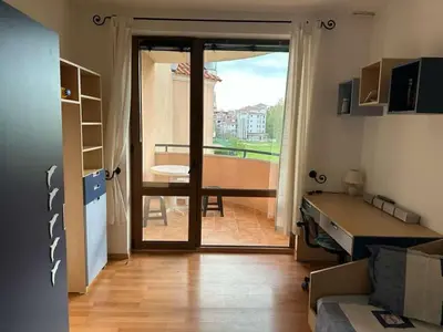 a living room with a door open to a balcony at Tania's Home in Sunny Beach