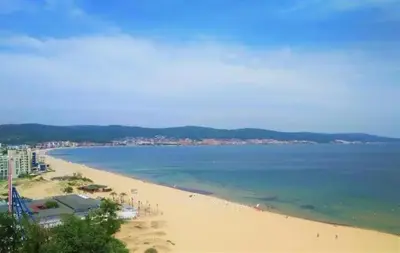 a view of a beach with the ocean and buildings at Avalon studio,Sunny Beach in Sunny Beach