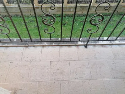 a black iron fence with grass behind it at Avalon studio,Sunny Beach in Sunny Beach