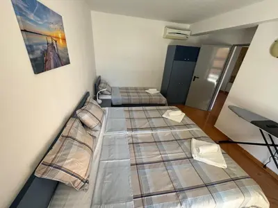 a room with three beds in a room at Black Pearl Apartment in Sozopol