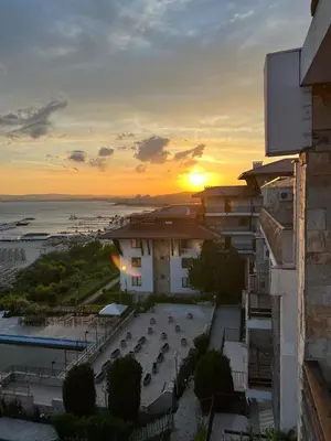 a view of a sunset from a building at Dolce Vita Premium Apartment Panorama Sea View in Sveti Vlas