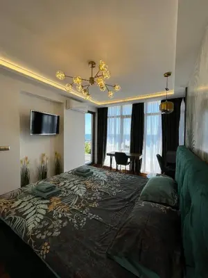 a bedroom with a large bed and a couch at Dolce Vita Premium Apartment Panorama Sea View in Sveti Vlas