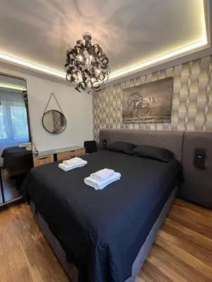 a bedroom with a bed with two towels on it at Dolce Vita Premium Apartment Panorama Sea View in Sveti Vlas