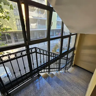 a staircase in a building with a view of a street at Serenity in the heart of Varna with free parking in Varna City