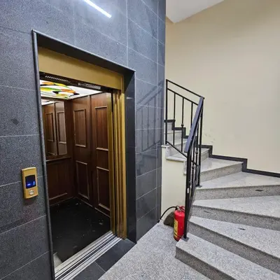 a building with a door and stairs with a fire hydrant at Serenity in the heart of Varna with free parking in Varna City