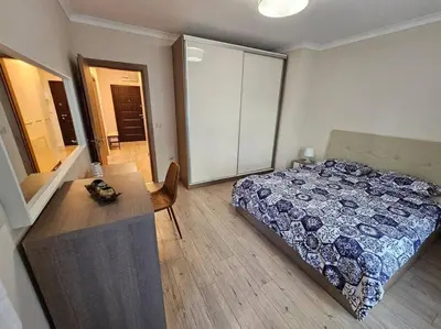 a bedroom with a bed and a dresser and a desk at Serenity in the heart of Varna with free parking in Varna City