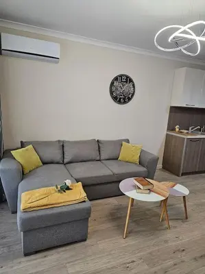 a living room with a couch and a table at Serenity in the heart of Varna with free parking in Varna City