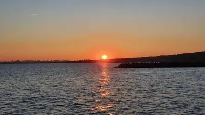 a sunset over a large body of water at Студио Сарафово in Burgas City