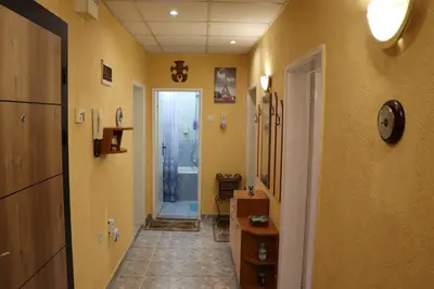 a hallway of a bathroom with a sink and a door at Супер апартамент-център Варна in Varna City