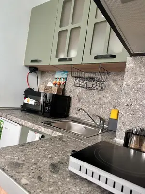a kitchen with a sink and a counter top at Glarus Apartment with Infinity Sea View in Varna City