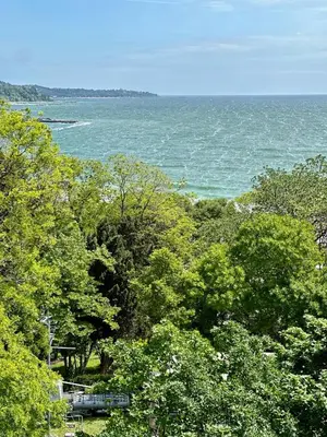 a view of a body of water with trees at Glarus Apartment with Infinity Sea View in Varna City
