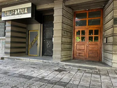 a building with a wooden door and a sign on it at Glarus Apartment with Infinity Sea View in Varna City