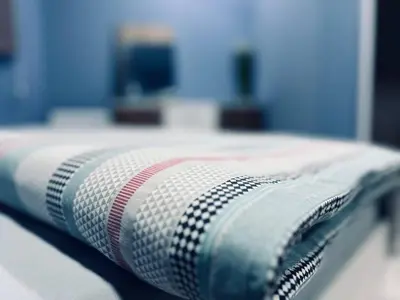 a close up of a blanket on a bed at NJ Deluxe rooms in Varna City