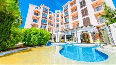 a hotel with a swimming pool in front of a building at ROMANCE MARIN 410 Studio Sunny Beach in Sunny Beach