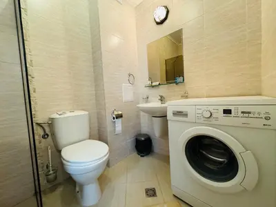 a bathroom with a toilet a sink and a washing machine at ROMANCE MARIN 410 Studio Sunny Beach in Sunny Beach