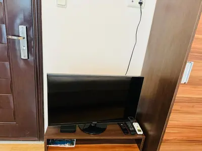 a television sitting on a table in front of a door at ROMANCE MARIN 410 Studio Sunny Beach in Sunny Beach
